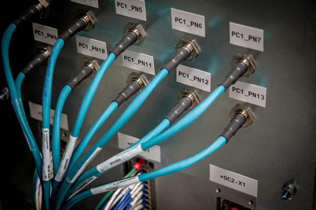 Labeled pneumatic manifold connections with blue field wiring.