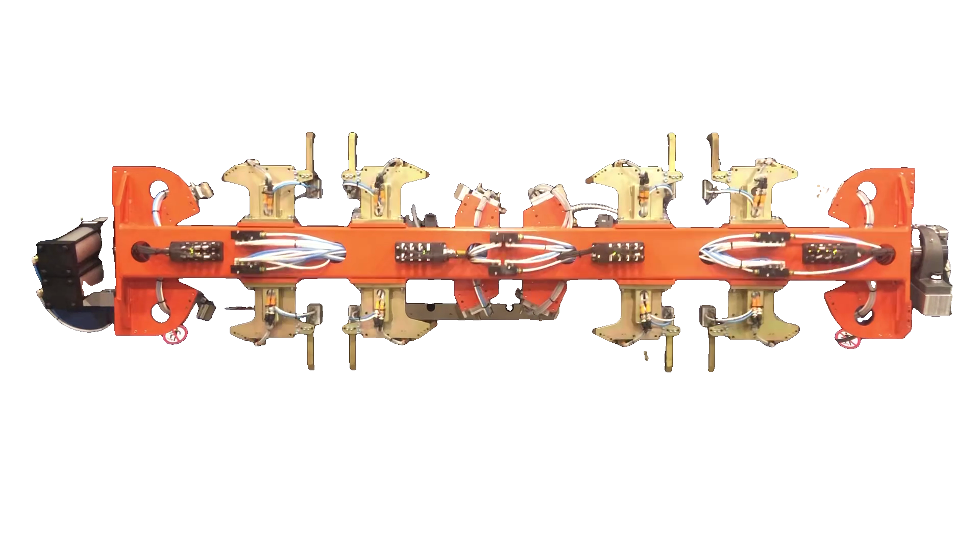 Orange multi-station laser fixture with clamps and protected utilities.
