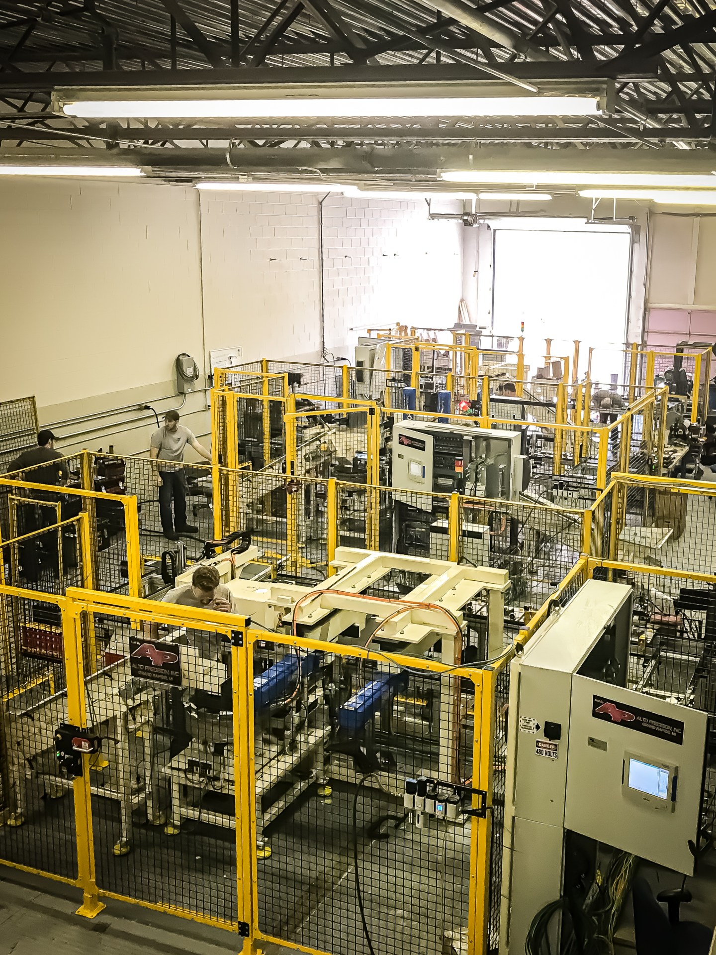 Large offsite machine-building and storage space with guarded equipment.