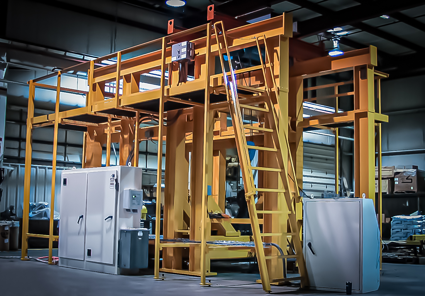 Large custom machine structure with stairs and an elevated work platform.